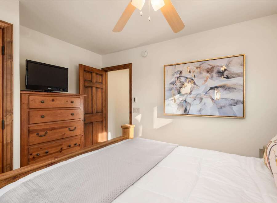 This cozy bedroom features a comfortable bed with a soft, inviting comforter and a stylish, decorative pillow.