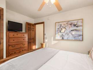 This cozy bedroom features a comfortable bed with a soft, inviting comforter and a stylish, decorative pillow.