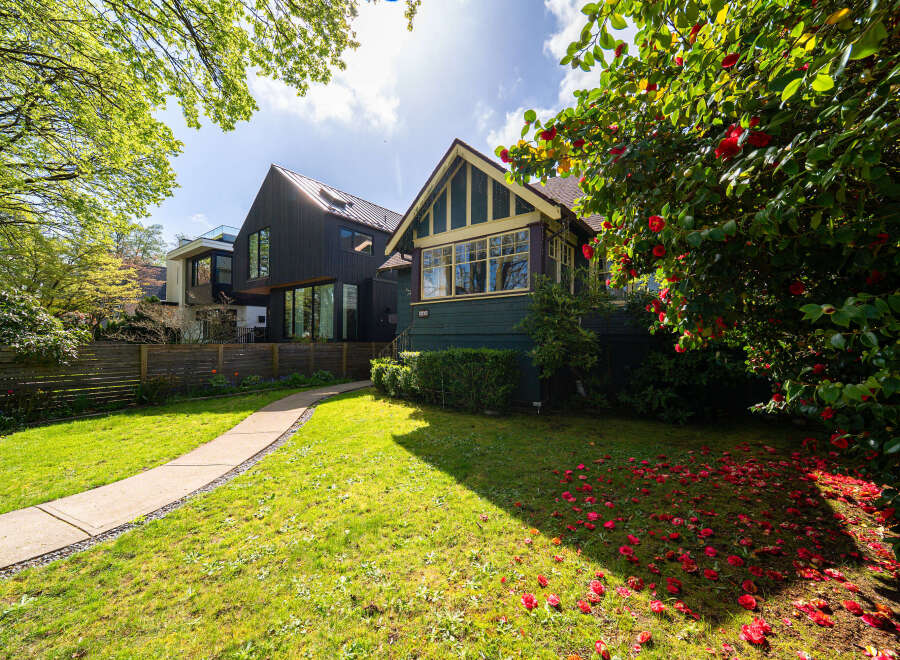 This stunning property boasts a beautifully landscaped front yard with a winding pathway leading to the entrance.