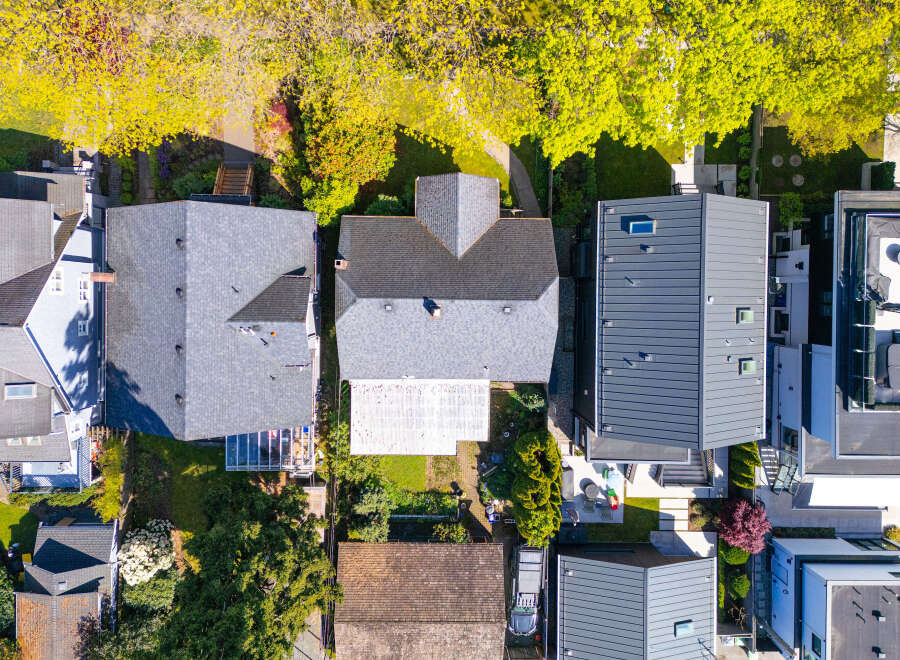 An aerial view showcases a collection of modern homes, each with unique architectural designs and features.