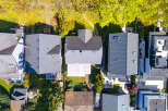 An aerial view showcases a collection of modern homes, each with unique architectural designs and features.