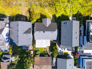 An aerial view showcases a collection of modern homes, each with unique architectural designs and features.