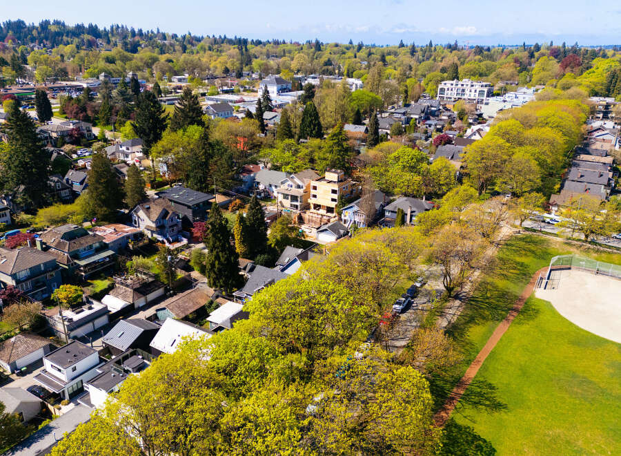 This stunning aerial view showcases a beautiful neighborhood with lush greenery and well-maintained homes.