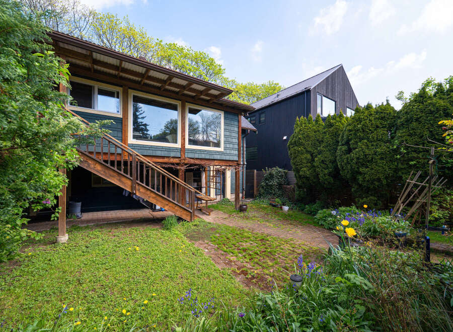 This charming property boasts a unique architectural design with a blend of modern and rustic elements.