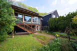 This charming property boasts a unique architectural design with a blend of modern and rustic elements.