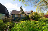 Charming craftsman-style home with a welcoming facade and lush landscaping.