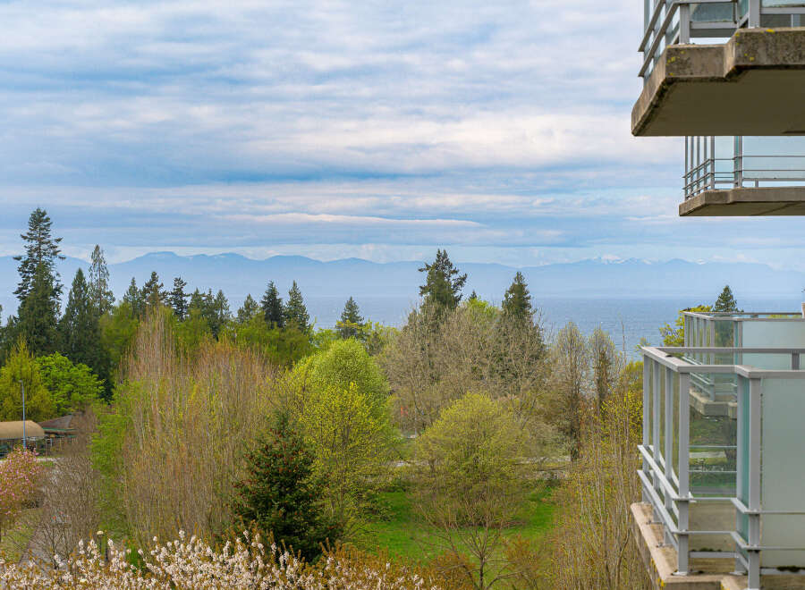Enjoy breathtaking views from this stunning property, featuring a spacious balcony overlooking lush greenery and the serene ocean.