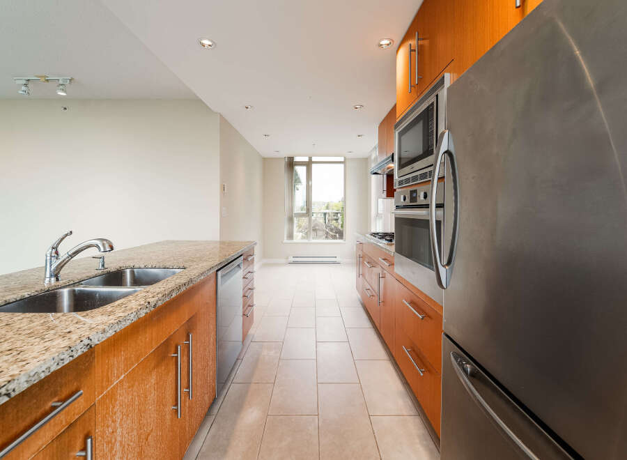 This stunning kitchen boasts modern appliances and sleek cabinetry, perfect for culinary enthusiasts.