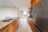 This stunning kitchen boasts modern appliances and sleek cabinetry, perfect for culinary enthusiasts.