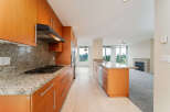 Step into this stunning kitchen, featuring sleek wooden cabinetry and elegant granite countertops.
