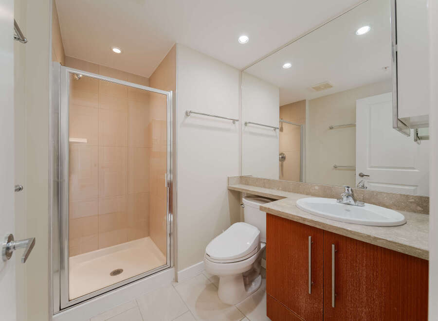 Step into a modern bathroom featuring a sleek glass-enclosed shower and elegant tile work.