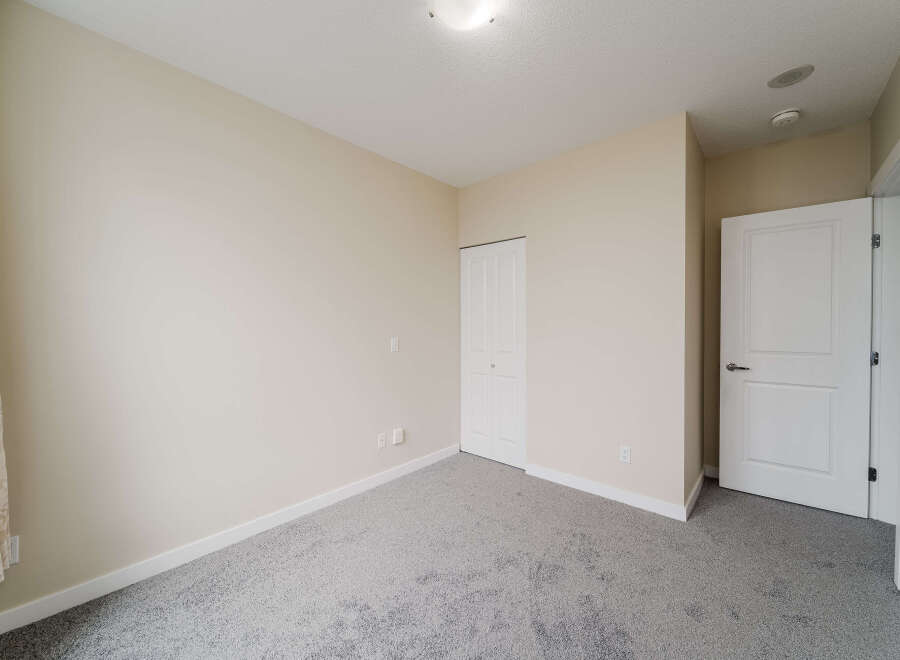 Step into this inviting bedroom, featuring a neutral color palette that offers a blank canvas for your personal style.