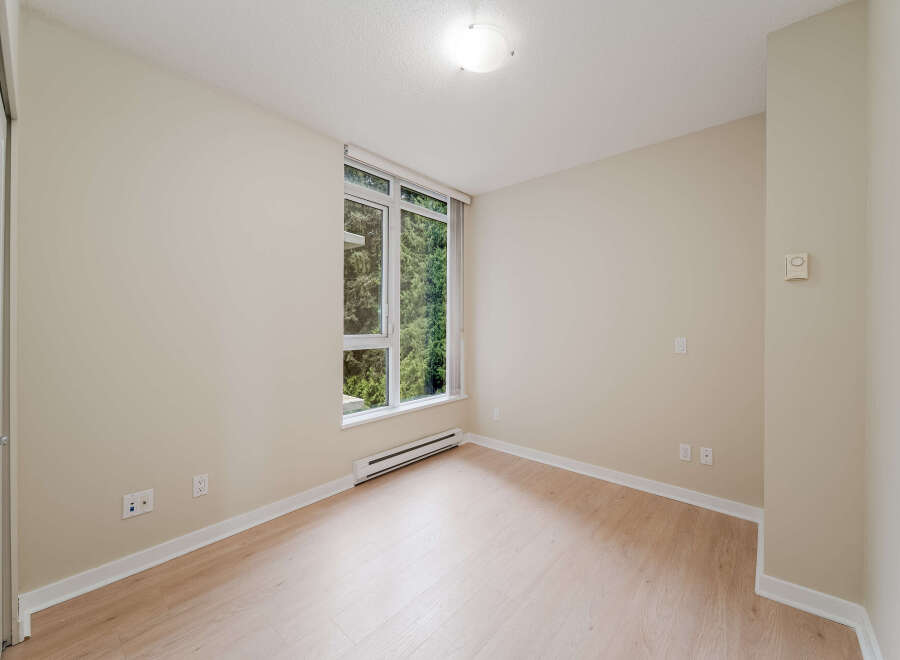 This bright and airy room features a large window that lets in plenty of natural light.