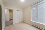 Step into this bright and airy bedroom, featuring a large window that floods the space with natural light.