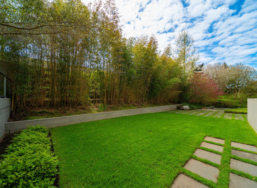This stunning property boasts a beautifully manicured lawn and a serene outdoor space, perfect for relaxation and entertaining.