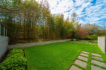 This stunning property boasts a beautifully manicured lawn and a serene outdoor space, perfect for relaxation and entertaining.