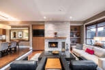 Experience luxury living in this stunning property, featuring a cozy fireplace and a modern entertainment center.