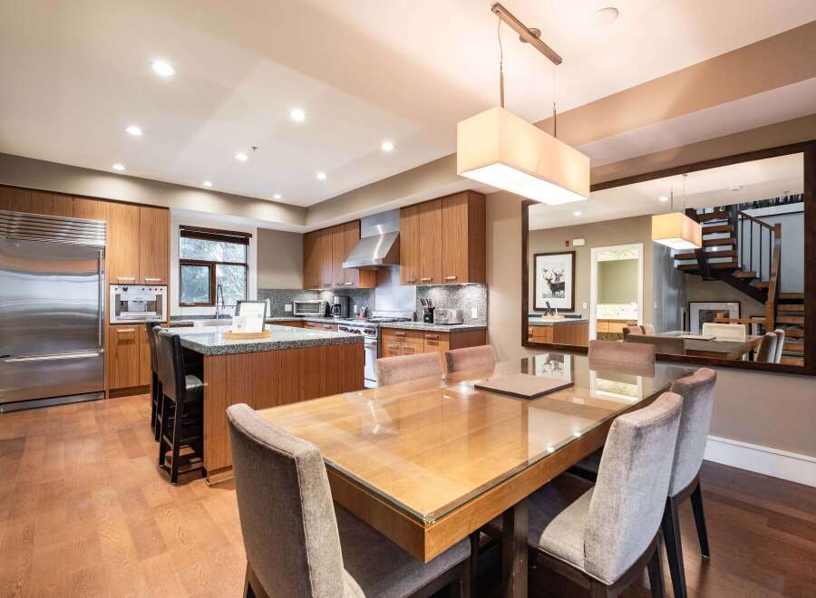 Step into luxury with this stunning kitchen and dining area.
