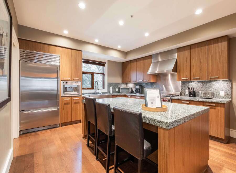This stunning kitchen boasts a modern design with sleek stainless steel appliances and custom cabinetry.