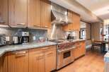 This stunning kitchen boasts modern design and high-end appliances, perfect for culinary enthusiasts.