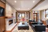 Experience luxury living in this stunning property, featuring a cozy fireplace and a modern entertainment setup.