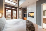 Experience luxury in this stunning bedroom featuring a modern fireplace and elegant marble accents.