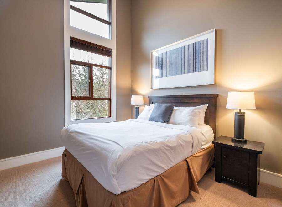 This inviting bedroom features a comfortable bed with crisp white linens and a stylish headboard.