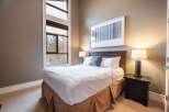 This inviting bedroom features a comfortable bed with crisp white linens and a stylish headboard.