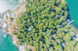 Discover a secluded waterfront property nestled amidst lush greenery.