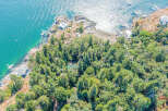 Discover a stunning waterfront property nestled amidst lush greenery.