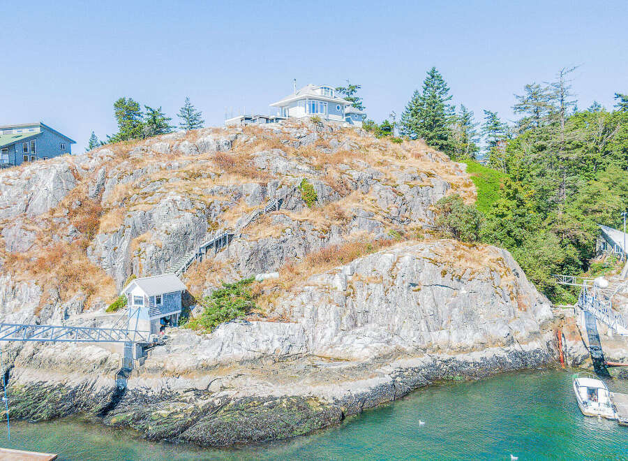 Discover a stunning waterfront property nestled on a rocky island, offering unparalleled privacy and breathtaking ocean views.