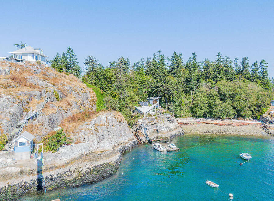 Discover a stunning waterfront property nestled on a rocky coastline, offering unparalleled views and privacy.