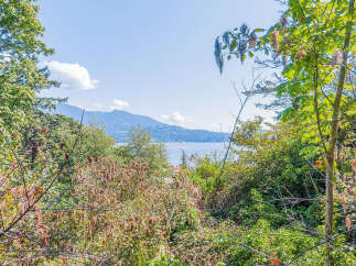Discover breathtaking views from this stunning property! This home offers a serene escape with lush greenery and panoramic water views.