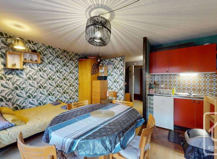 Discover this charming property featuring a cozy living space with a unique wallpaper design.