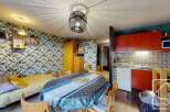 Discover this charming property featuring a cozy living space with a unique wallpaper design.