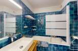 Step into this stylish bathroom featuring stunning blue tiles that create a serene and inviting atmosphere.