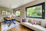 This stunning property boasts a modern interior with a spacious living area, perfect for entertaining.