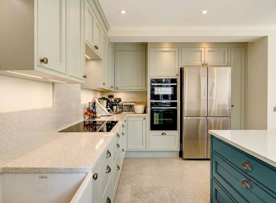 This stunning kitchen boasts a modern design with sleek cabinetry and high-end appliances.