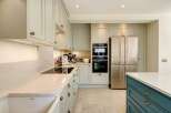 This stunning kitchen boasts a modern design with sleek cabinetry and high-end appliances.