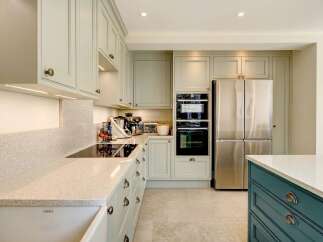 This stunning kitchen boasts a modern design with sleek cabinetry and high-end appliances.