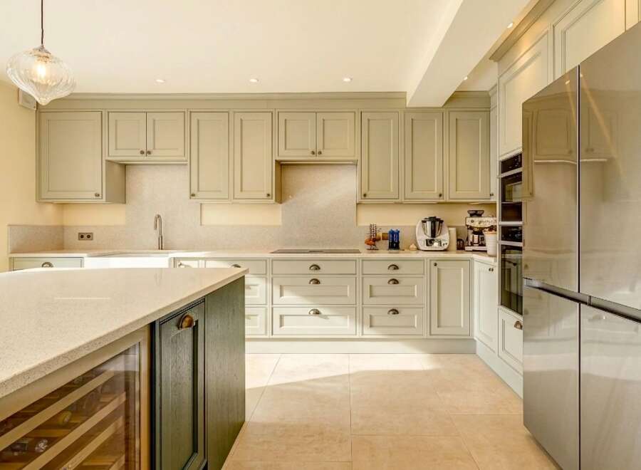 This stunning kitchen boasts a modern design with sleek cabinetry and a spacious layout, perfect for culinary enthusiasts.