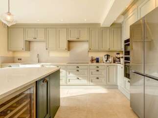 This stunning kitchen boasts a modern design with sleek cabinetry and a spacious layout, perfect for culinary enthusiasts.