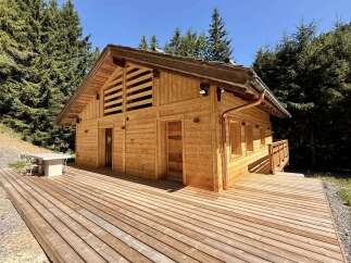 Discover a stunning wooden cabin nestled in a serene natural setting.