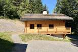 Discover a charming wooden cabin nestled in a serene natural setting.
