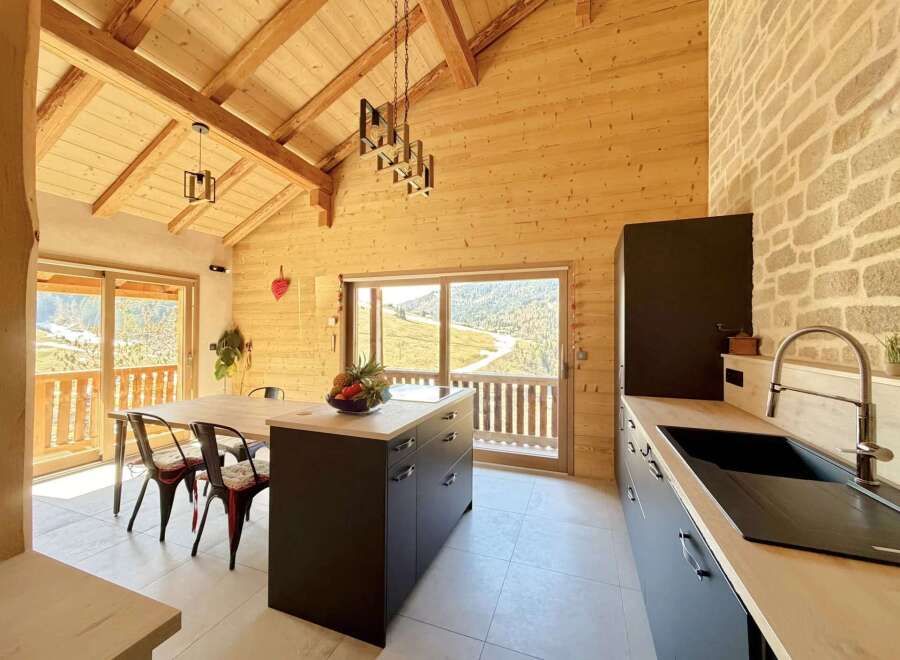 This stunning kitchen boasts a warm and inviting atmosphere with its wooden accents and modern design.