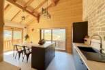 This stunning kitchen boasts a warm and inviting atmosphere with its wooden accents and modern design.
