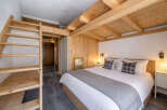 Discover the charm of this cozy bedroom featuring a unique wooden design.