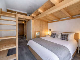 Discover the charm of this cozy bedroom featuring a unique wooden design.