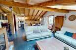 This stunning property boasts a warm and inviting living space with exposed wooden beams and a cozy atmosphere.