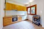 This charming kitchen features warm wooden cabinetry and a bright, inviting atmosphere.